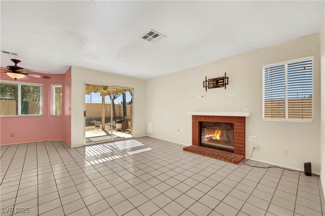 Unfurnished living room featuring visible vents, a fireplace, and light tile patterned floors | Image 19