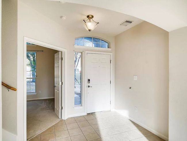 Entryway featuring plenty of natural light, baseboards, light tile patterned floors, and light carpet | Image 4