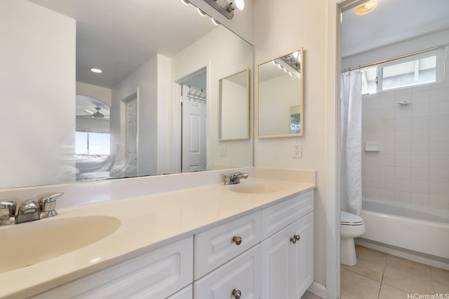 The master bathroom has dual sinks, bathtub, & shower. | Image 16