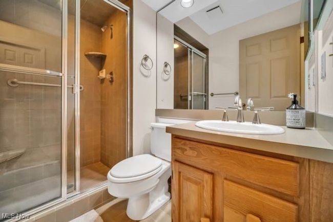 Bathroom with vanity, an enclosed shower, and toilet This can serve as private bathroom for the flex room, a powder room or a second bathroom for his/her bathrooms | Image 29