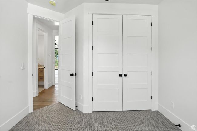 Unfurnished bedroom with carpet flooring and a closet | Image 25