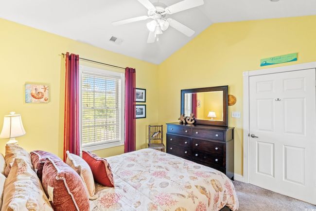 Bedroom featuring lofted ceiling, carpet, and ceiling fan | Image 11