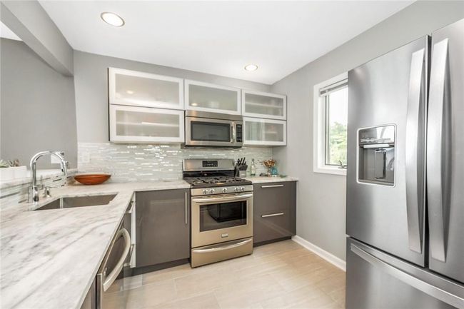 Modern kitchen with SS appliances. | Image 12