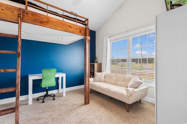 Carpeted bedroom with lofted ceiling and multiple windows | Image 26