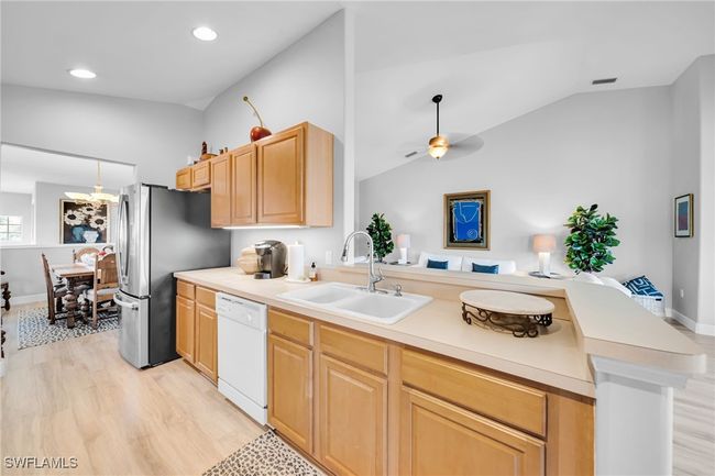 Kitchen featuring Laminate Wood flooring, New Refrigerator, Enormous water View | Image 9