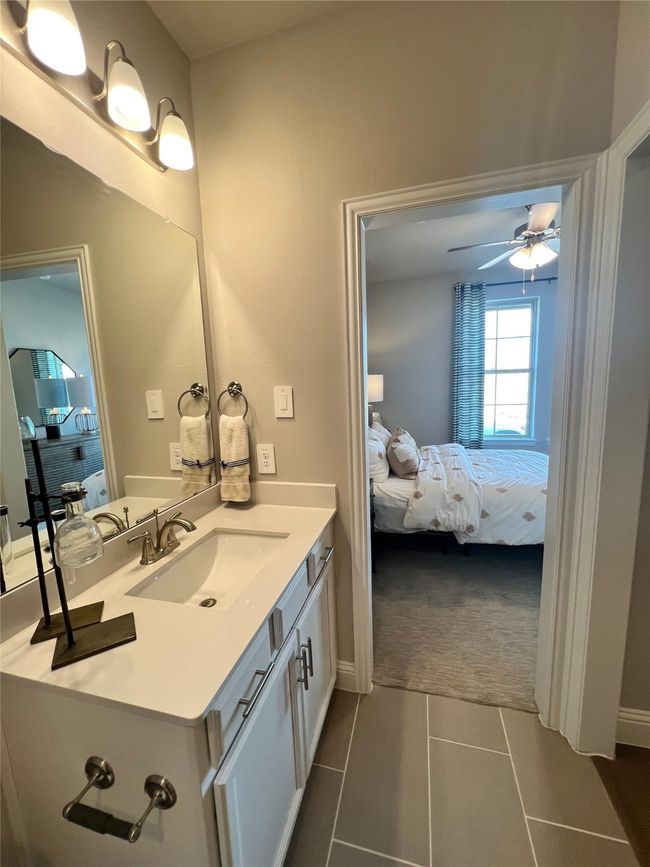 Bathroom featuring ensuite bathroom, vanity, a ceiling fan, and tile patterned floors | Image 14