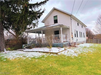 View of front of house with a lawn and a porch | Image 1