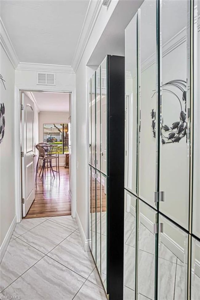 Hallway featuring ornamental molding, visible vents, and baseboards | Image 33