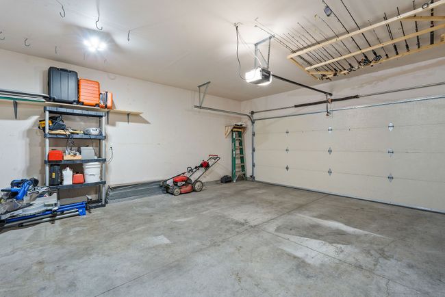 .2 car garage with space for storage and a workbench. | Image 14