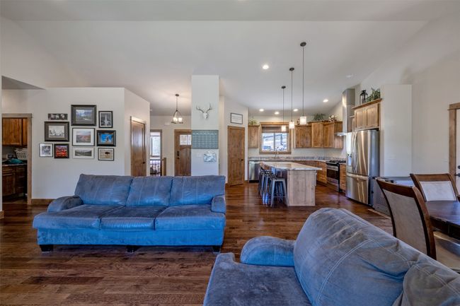 Living area with dark wood-style floors and recessed lighting | Image 8