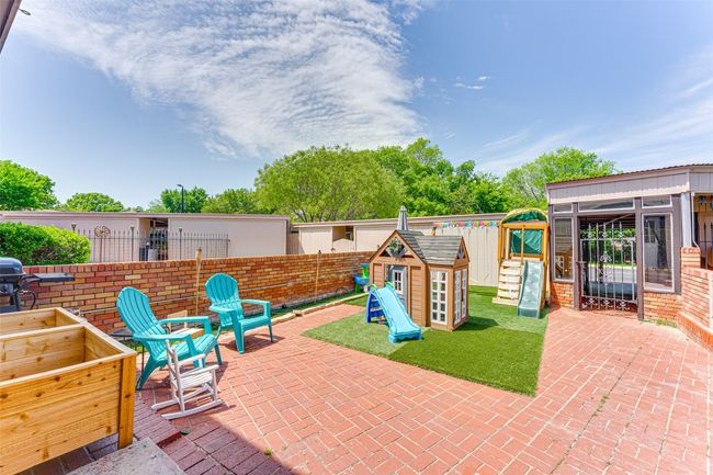 View of patio / terrace featuring a fenced backyard, a playground, and an outdoor structure | Image 23