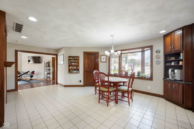 dining room featuring visible vents, recessed lighting, an inviting chandelier, light tile patterned floors, and baseboards | Image 18