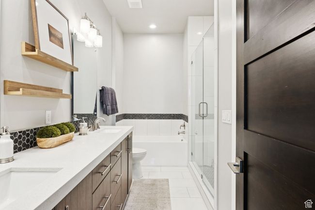 Full bathroom featuring double vanity, a garden tub, a shower stall, tile patterned floors, and recessed lighting | Image 23