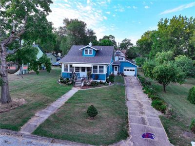 View of front of property featuring a garage, a front yard, and covered porch | Image 3