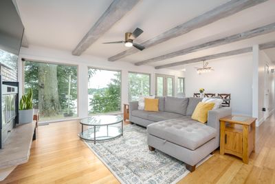 Beautiful Bamboo flooring and full view of windows overlooking scenic lake views | Image 3