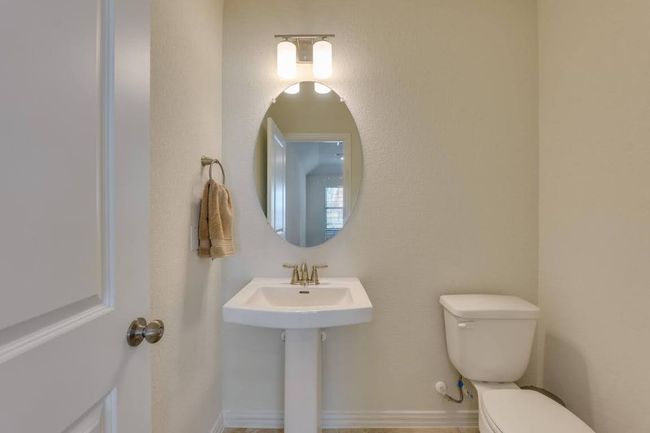 Bathroom featuring toilet and a sink | Image 31