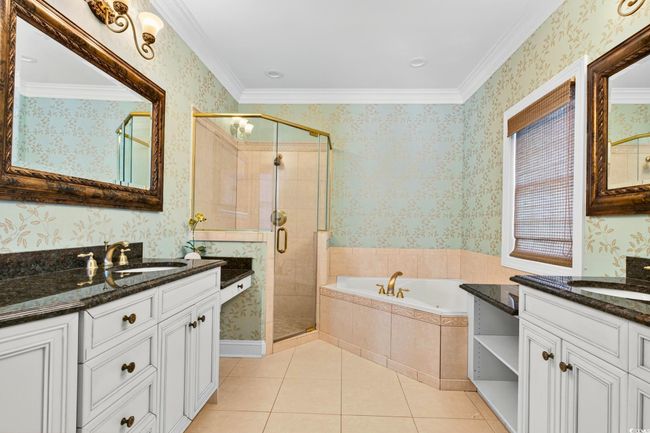 Full bath with wallpapered walls, two vanities, a stall shower, a garden tub, and tile patterned floors | Image 27