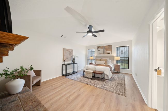 Primary bedroom with fireplace and vaulted ceiling. | Image 11