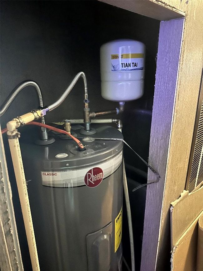Utility room featuring electric water heater | Image 21