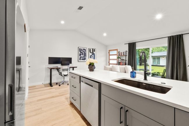 Kitchen with appliances with stainless steel finishes, a sink, gray cabinetry, light countertops, and recessed lighting | Image 7