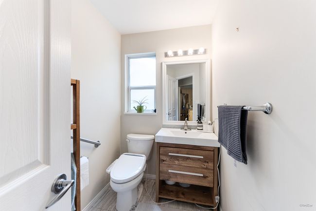 Half bathroom featuring vanity, toilet, and baseboards | Image 10