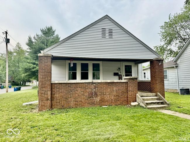 view of front of house with a front lawn and brick siding | Image 33