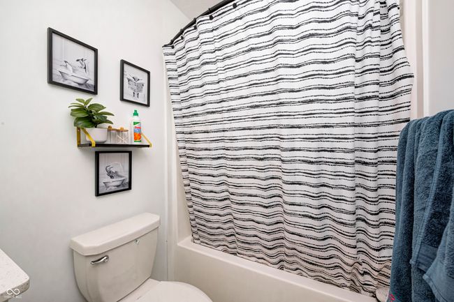full bath with shower / tub combo with curtain and toilet | Image 31