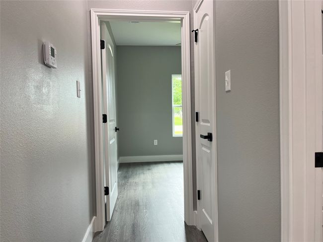 Corridor with dark wood-style floors and baseboards | Image 14