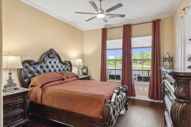 Bedroom featuring dark wood finished floors, ornamental molding, baseboards, and ceiling fan | Image 16
