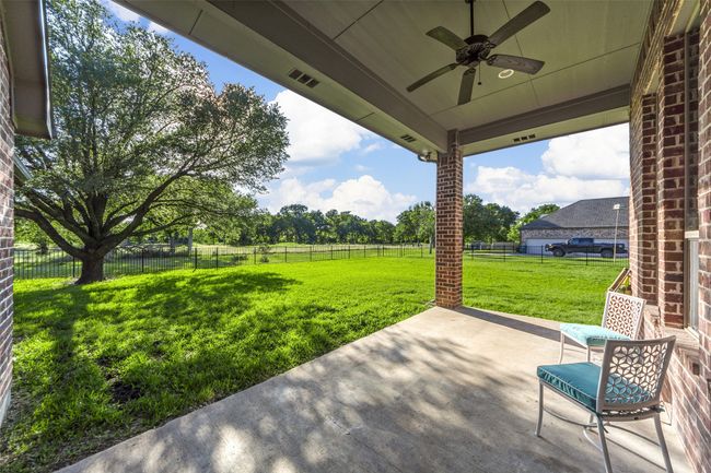 Here's your spacious back porch to see those beautiful sunsets! Yes, the back of the home faces West! | Image 31
