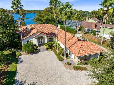 Privacy and practicality is a key with a huge front paver courtyard and drive leading to an oversized 3 car garage and private gated boat access to the lake. | Image 3