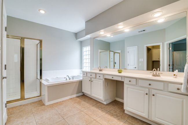Soak in the tub after a long day in the spa like bathroom. | Image 19