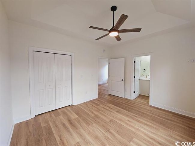 Unfurnished bedroom with ceiling fan, a closet, light wood-style flooring, and baseboards | Image 31