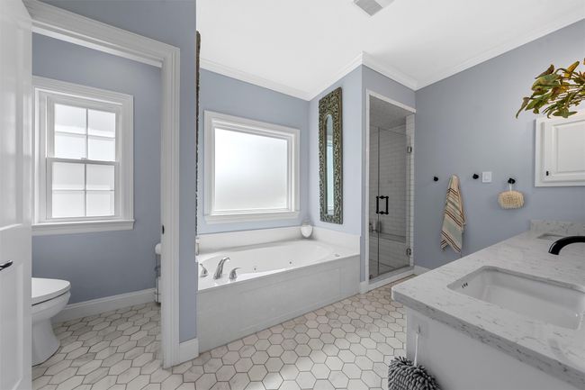 Full bath with toilet, crown molding, a sink, and a wealth of natural light | Image 18