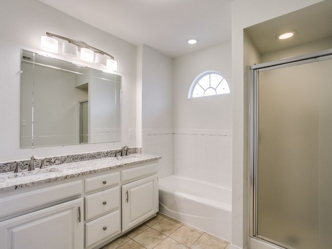 Full bathroom featuring double vanity, a bath, a stall shower, tile patterned flooring, and recessed lighting | Image 19