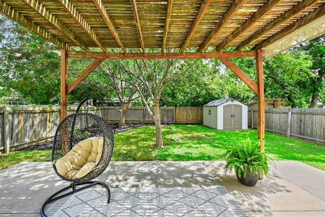 Fenced backyard featuring a storage shed, a patio area, and a pergola | Image 31
