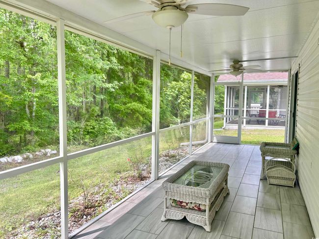 Sunroom / solarium featuring ceiling fan and plenty of natural light | Image 4