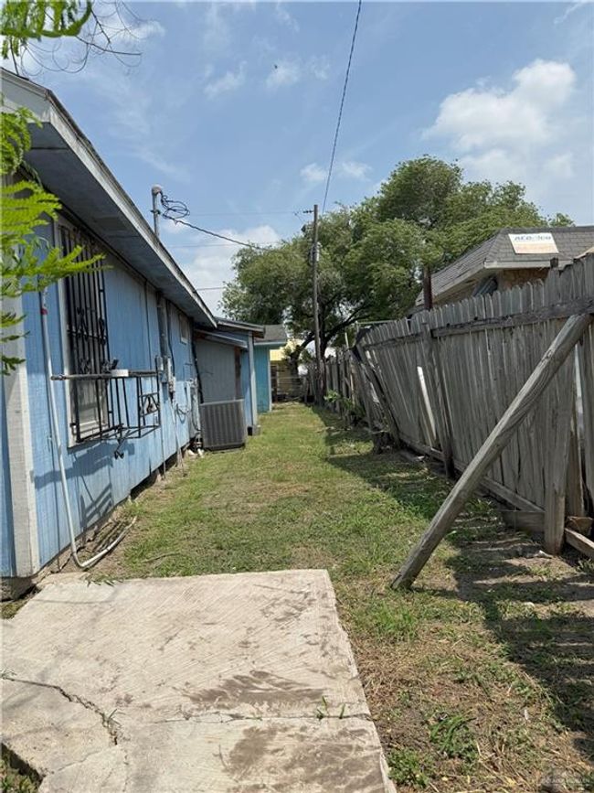 View of yard featuring fence, a patio area, and central AC | Image 25