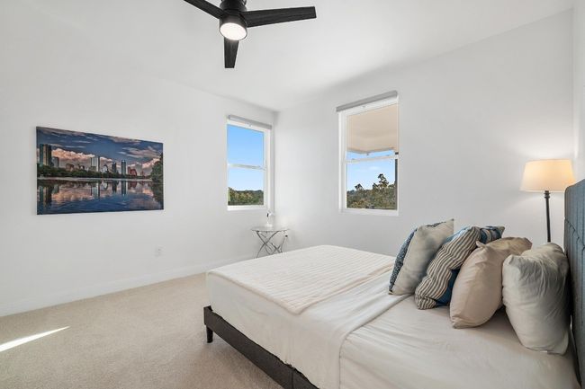 A generously sized guest suite on the second level offers a full bath with an oversized walk-in shower, quartz countertops, luxury finishes, and a spacious walk-in closet—seamlessly combining elegance and comfort. | Image 24