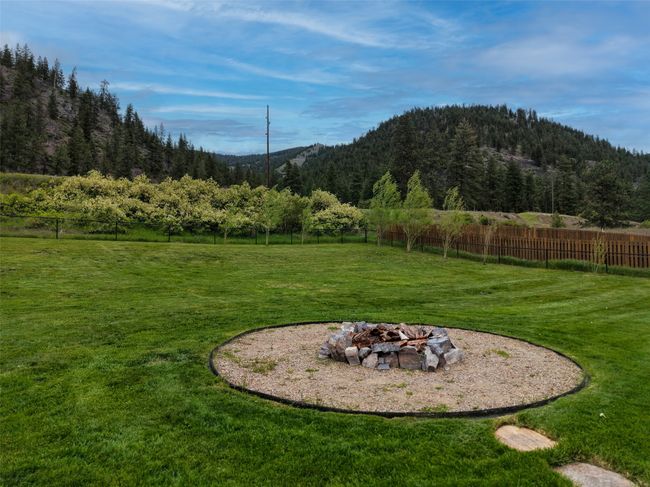 View of yard with an outdoor fire pit and a mountain view | Image 44
