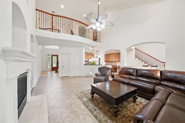 Great view of the home from the opposite side of the living room showing where kitchen and breakfast area are situated. | Image 14