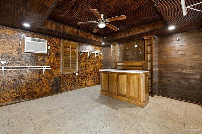 Bar with wood walls, a wall mounted AC, and wood ceiling | Image 16