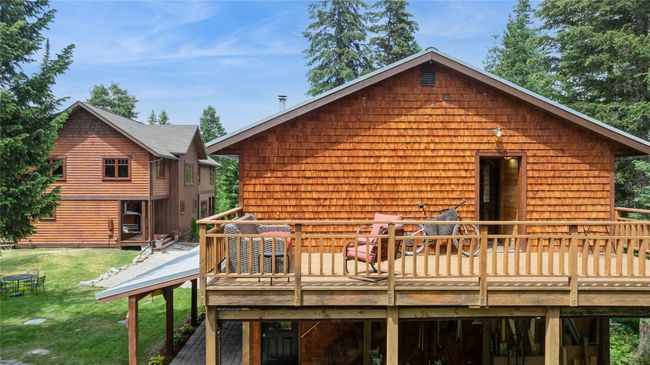 Back of apartment/garage with a deck and a yard | Image 8