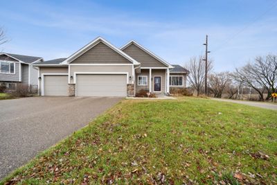 Another view the front of the property with 3-Car garage and porch. Large corner lot across the prairie. | Image 3