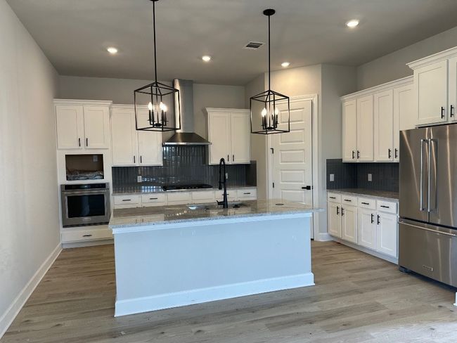 The fully loaded kitchen is like a playground for your inner chef complete with stainless steel kitchen appliances and an oversized island. | Image 4