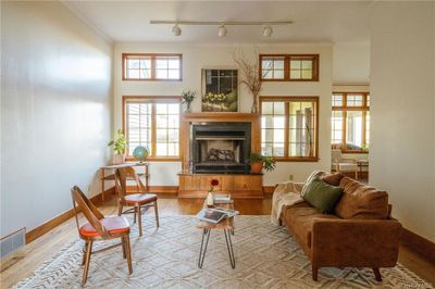 Living area featuring crown molding, light wood-type flooring, and rail lighting | Image 3