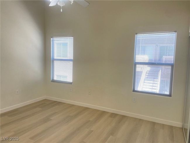 Unfurnished room featuring light wood-style floors, healthy amount of natural light, and ceiling fan | Image 13