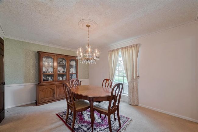 Elegant dining room with a chandelier, perfect for hosting memorable dinners. | Image 5