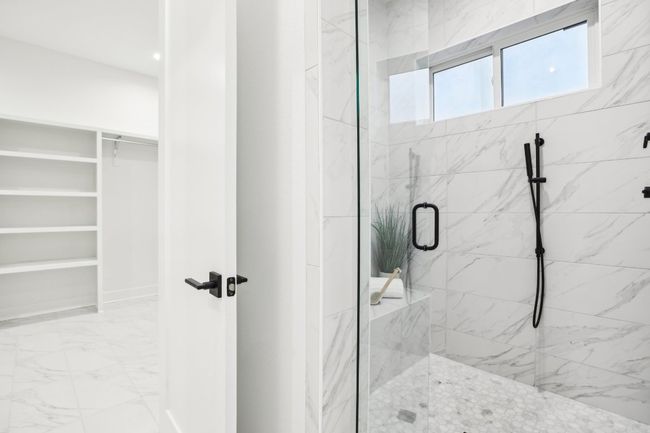 Indulge in spa-level comfort with a deep soaking tub and oversized walk-in shower. | Image 25