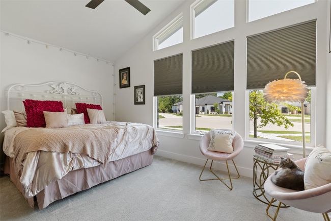 Bedroom with high vaulted ceiling, baseboards, ceiling fan, and carpet floors | Image 25